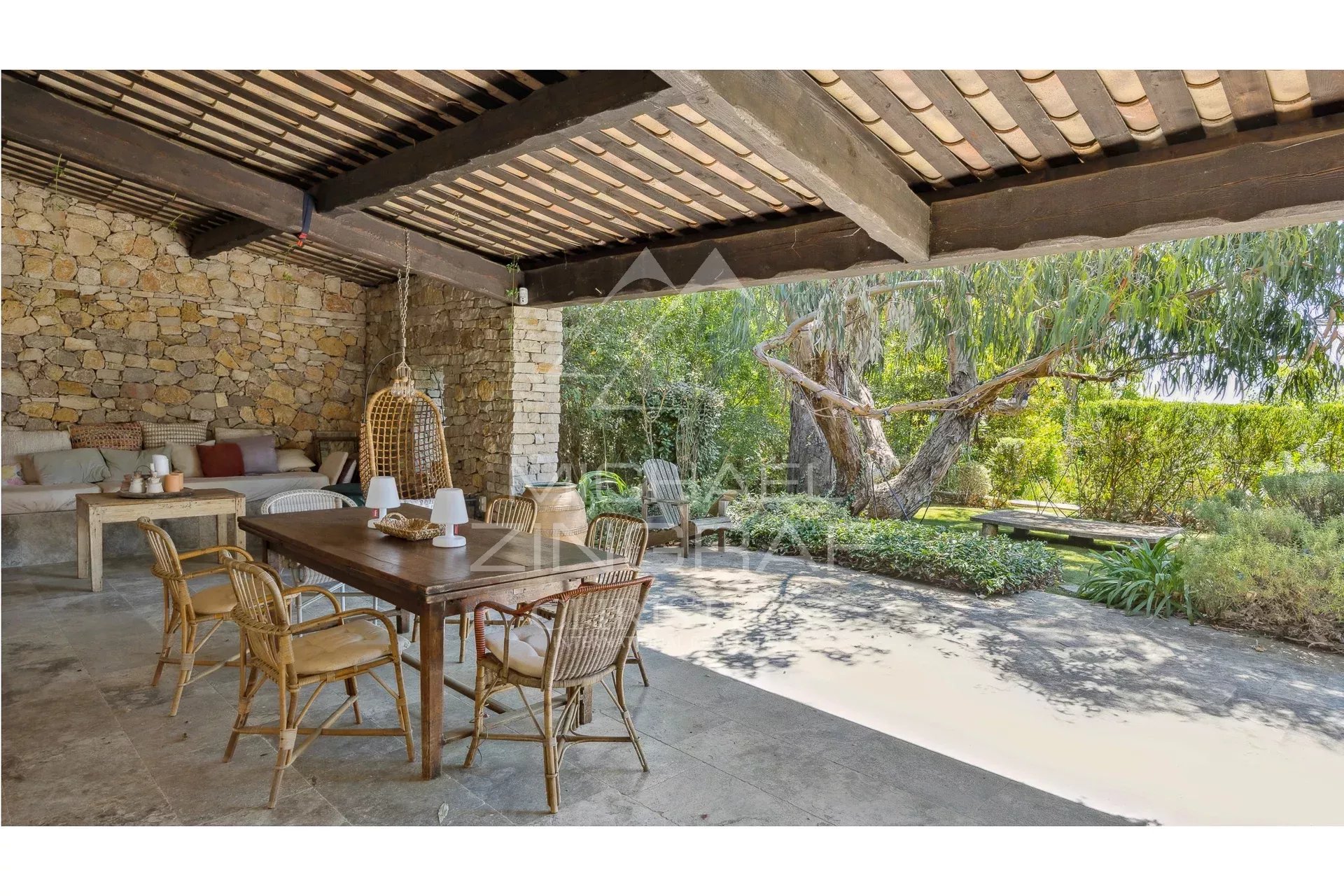 Terrace of a Mediterranean villa with wooden furniture and plants, Châteauneuf-Grasse.