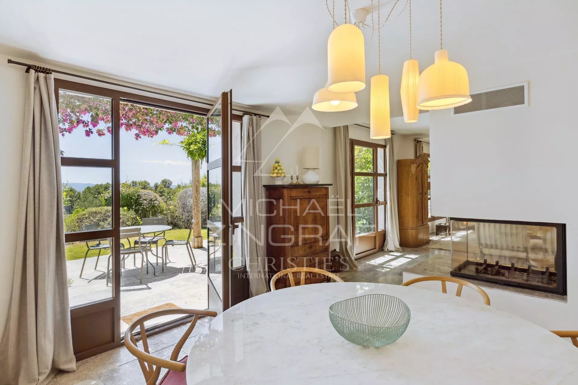 Interior of a Mediterranean villa with a view, dining table and fireplace