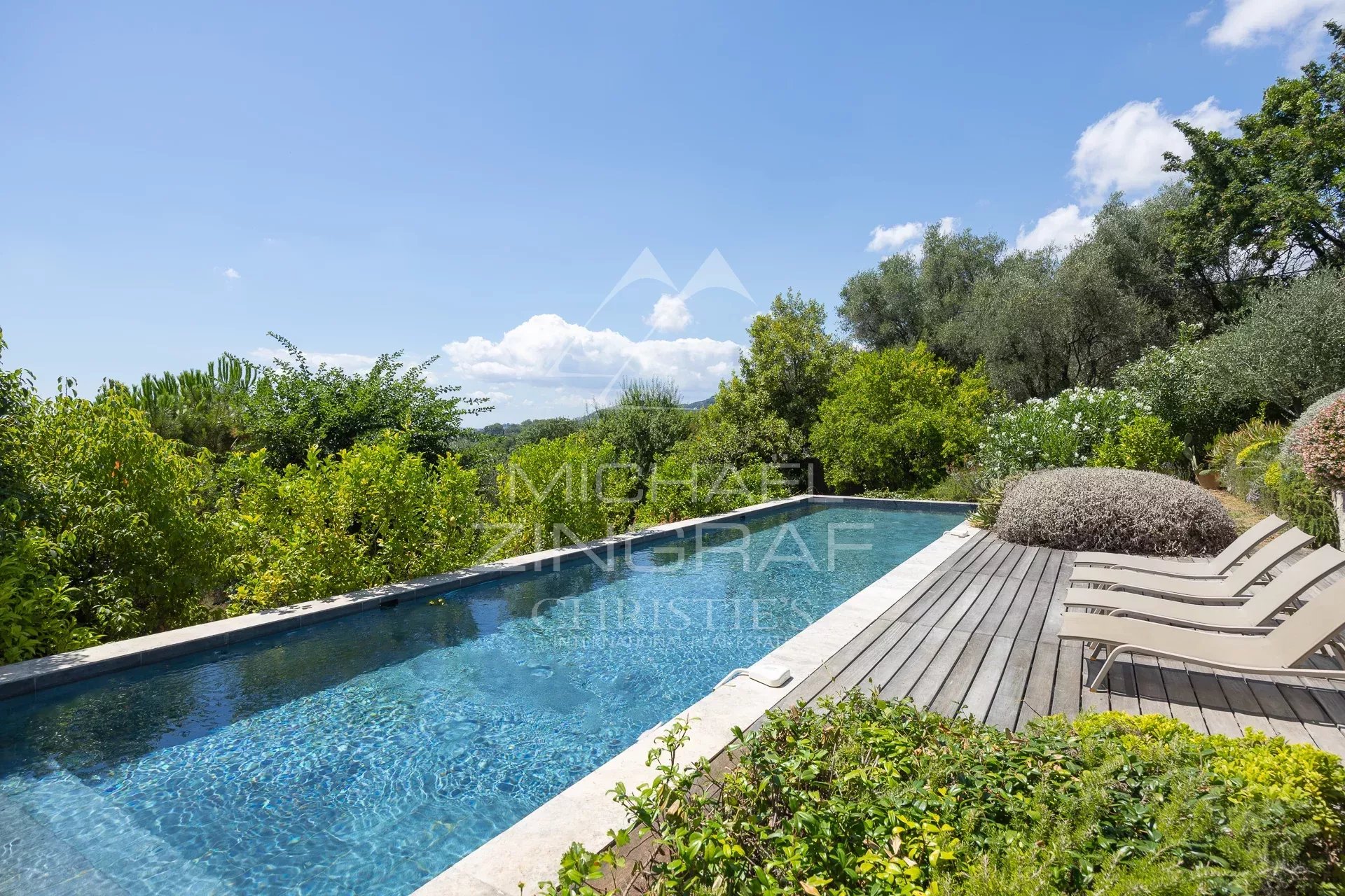 Swimming pool of a Mediterranean villa surrounded by greenery in Châteauneuf-Grasse.
