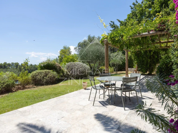 Terrace of a Mediterranean villa with garden furniture and lush vegetation in Châteauneuf-Grasse.