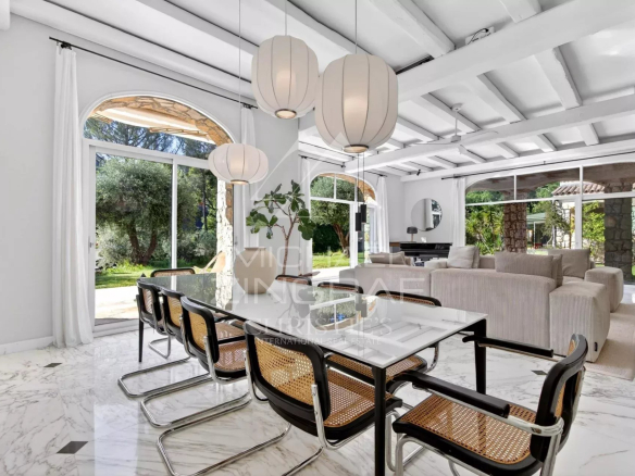 Interior of a renovated house with a modern dining room and natural light.