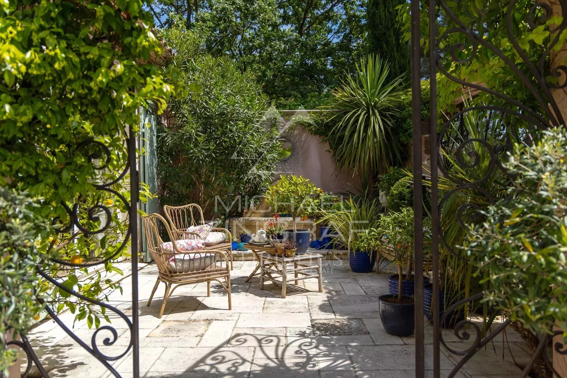 Outdoor space on an estate with chairs and plants, Draguignan.