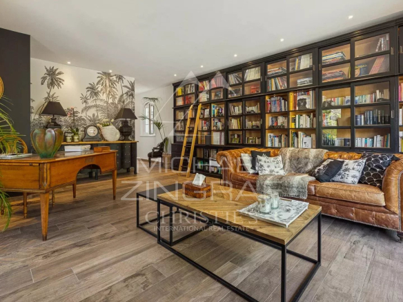 Interior of an elegant living room with library, leather sofa and refined decoration in an estate in Draguignan.