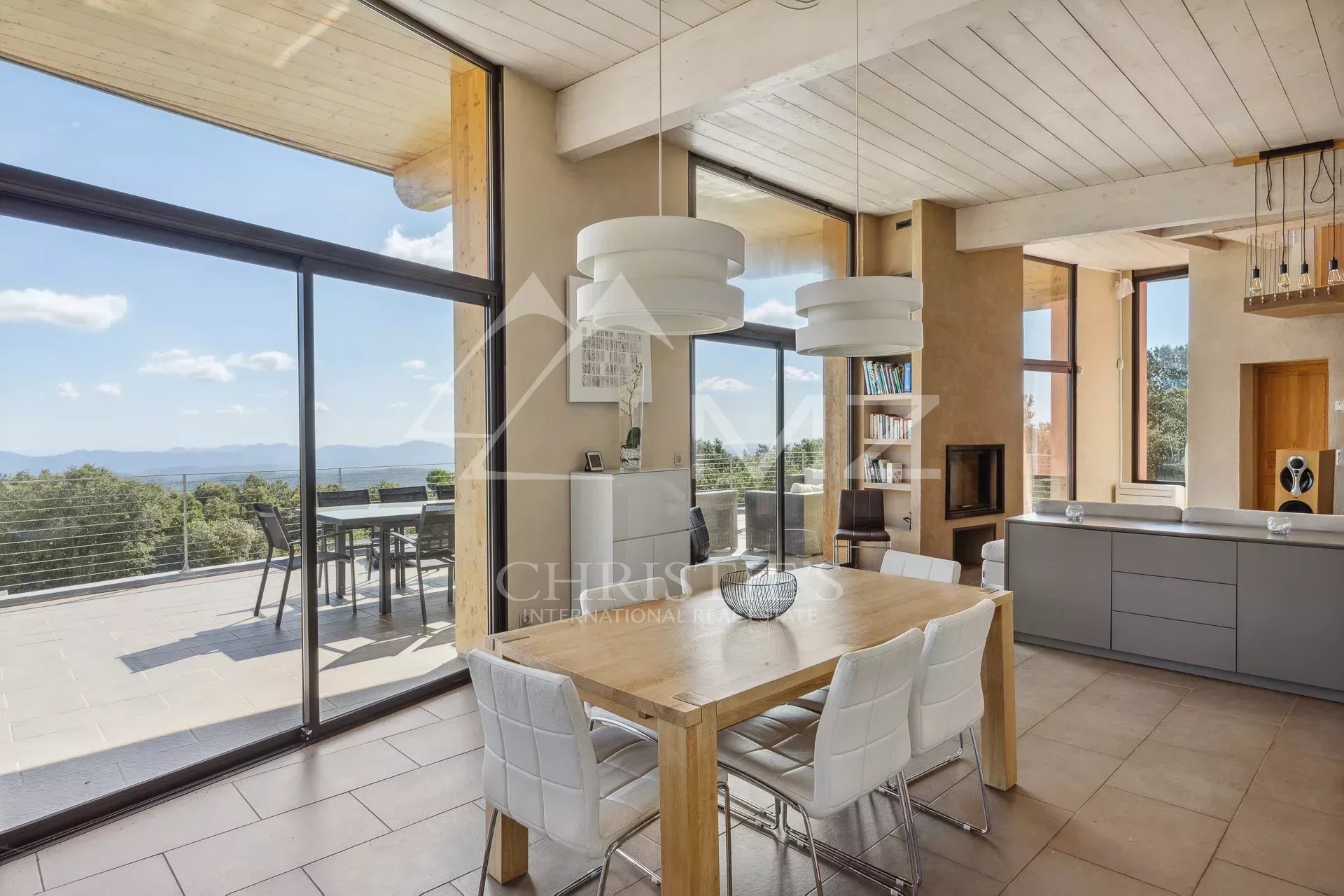 Interior of a modern villa with open kitchen and views of nature in Fayence.