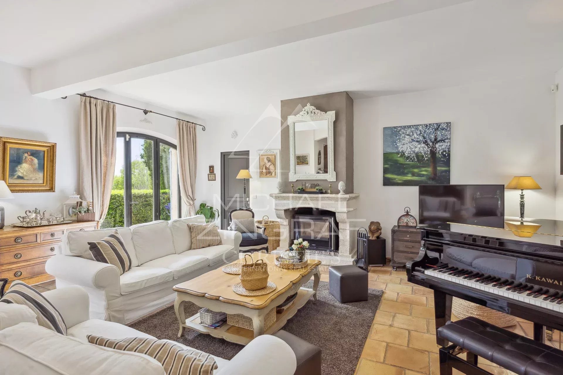 Interior of an elegant country house with a bright living room, piano and fireplace.