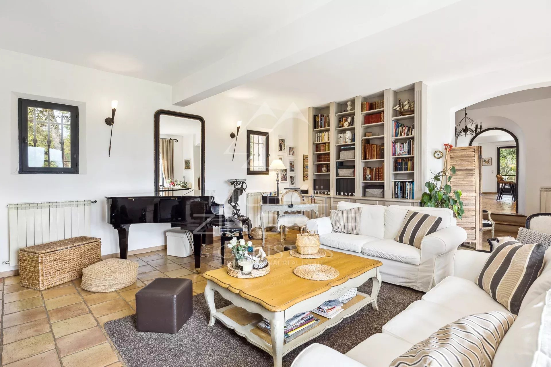 Interior of an elegant country house with a comfortable living room and library.