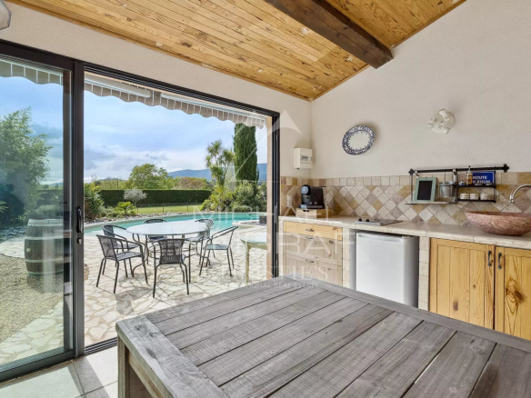 Outdoor space with swimming pool and barbecue area in a bastide near Fayence.