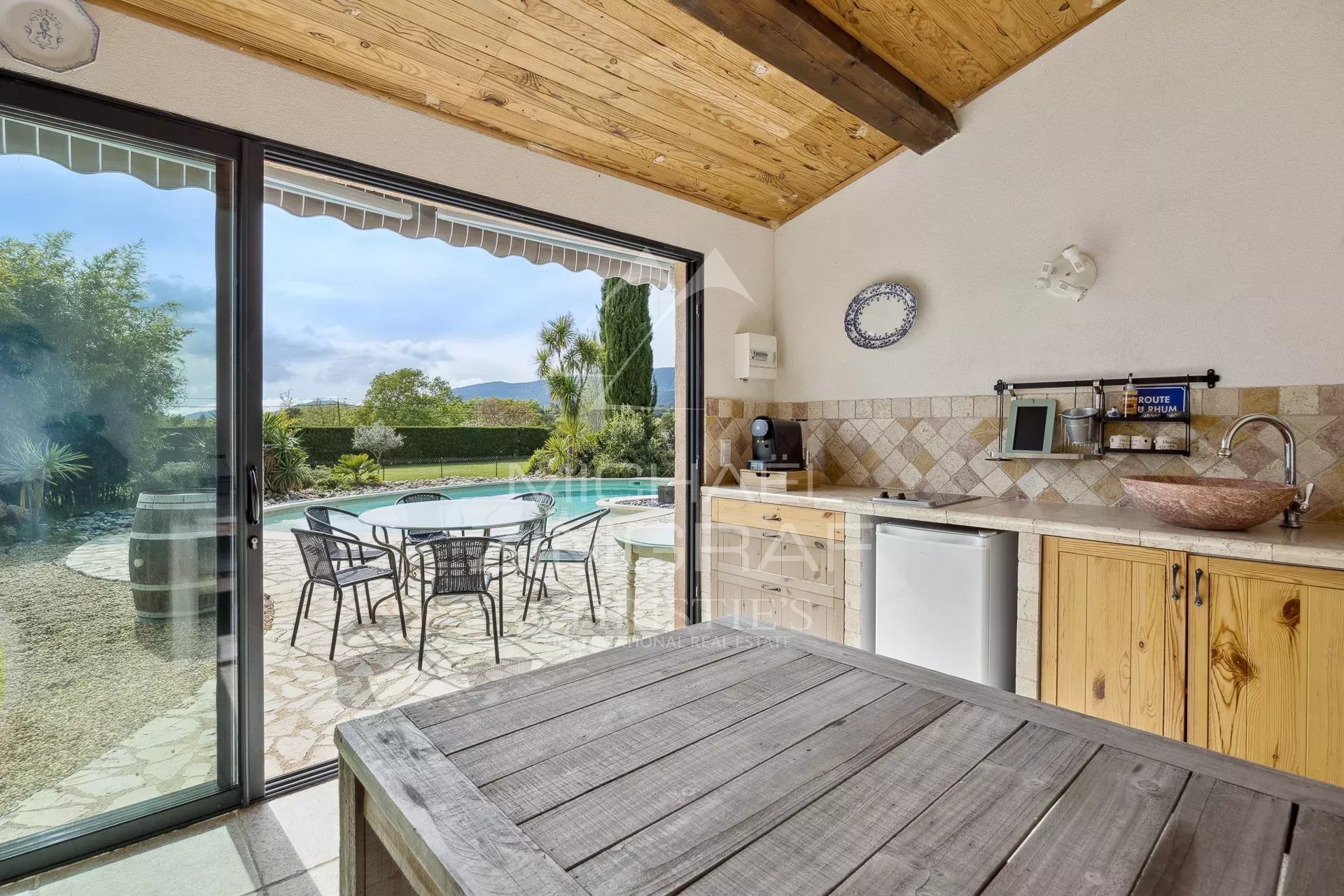 Outdoor space with swimming pool and barbecue area in a bastide near Fayence.