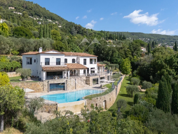 Villa contemporaine avec piscine et jardin paysager à Grasse, vue sur les collines et la mer.