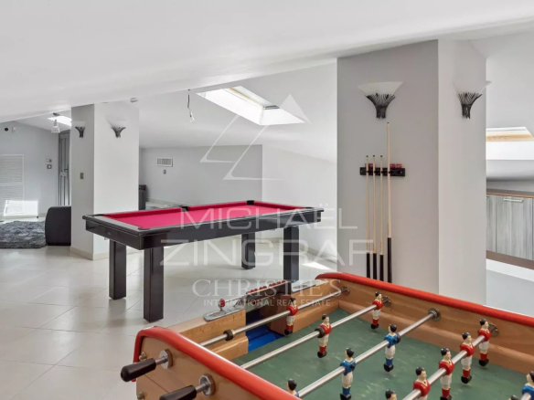 Interior of a villa with games room, pool table and foosball table.