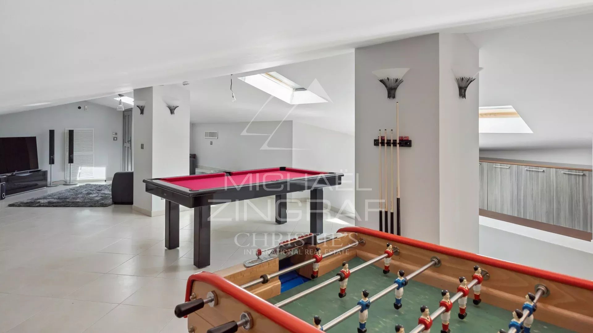 Interior of a villa with games room, pool table and foosball table.