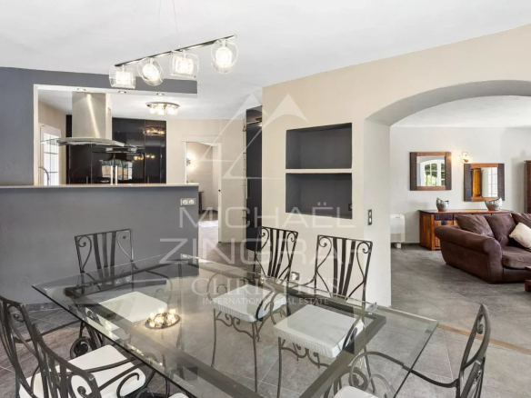 Interior of a family villa with dining room and living room, elegantly decorated.