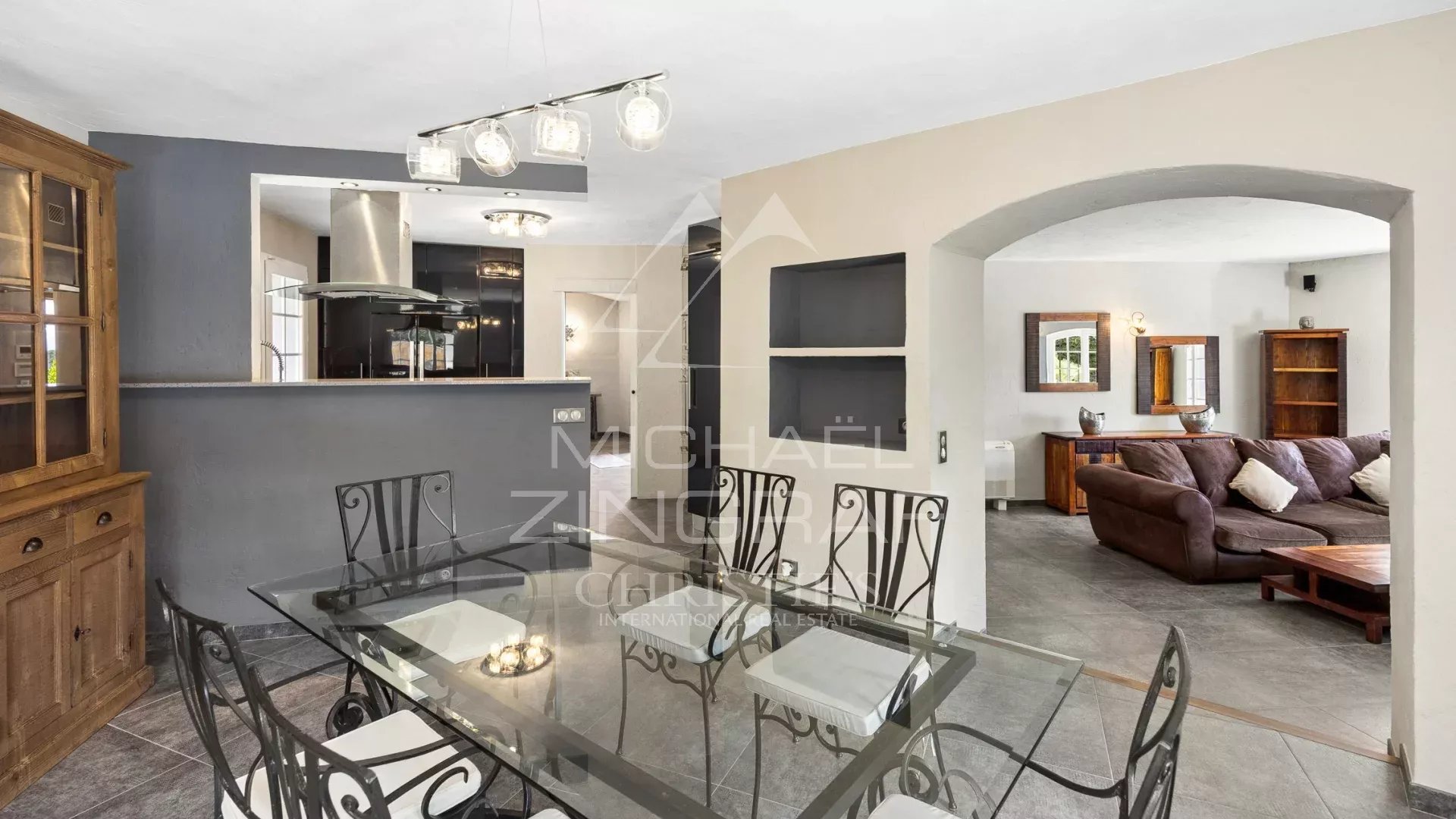 Interior of a family villa with dining room and living room, elegantly decorated.