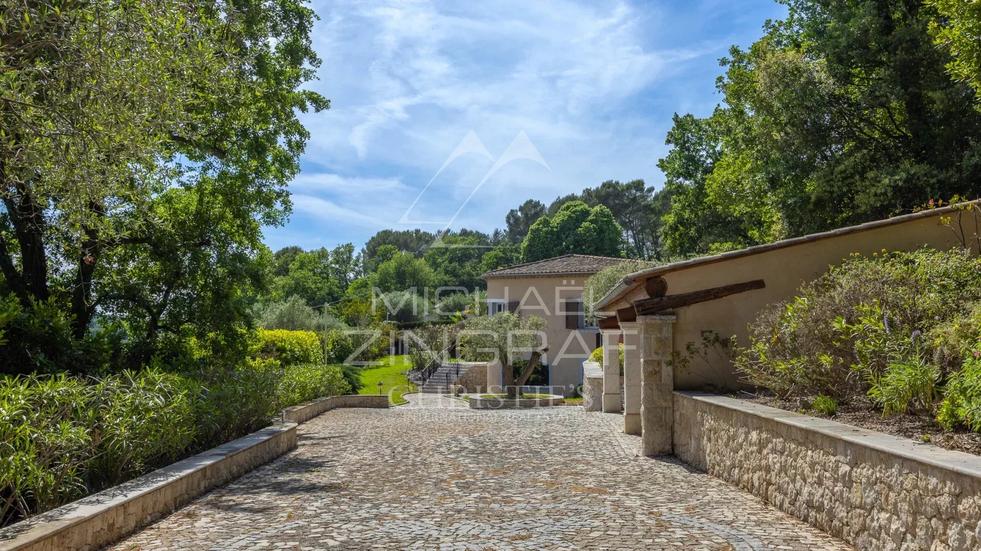 Driveway leading to a family villa surrounded by greenery in Opio.