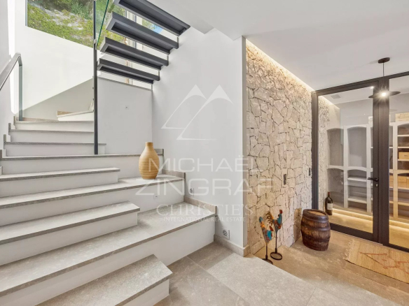 Modern stone staircase with glass railings in an elegant villa.