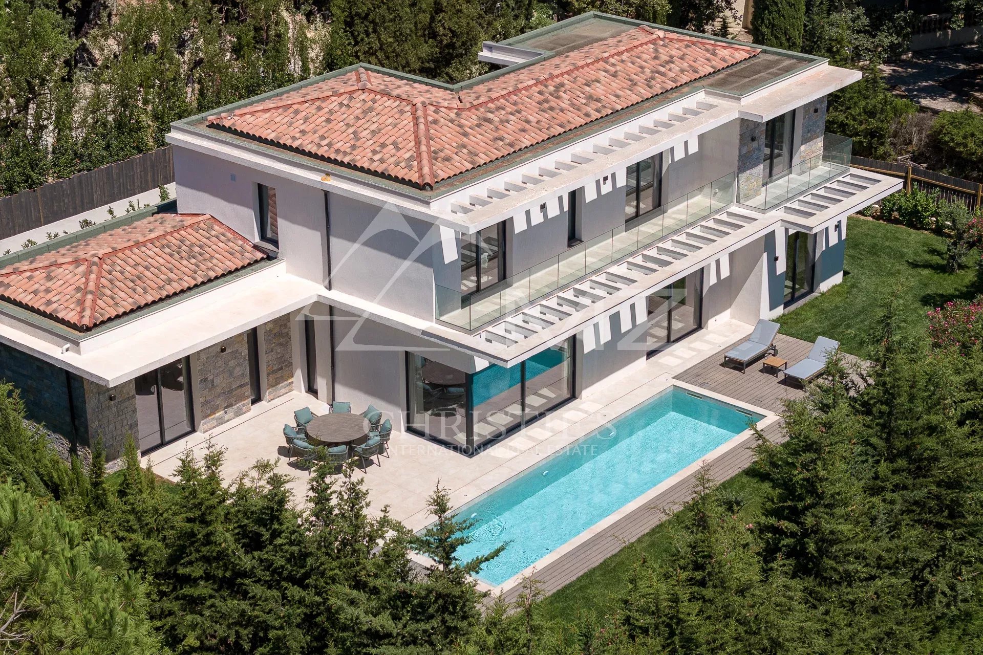 Contemporary villa in Mougins New contemporary villa with swimming pool in Mougins, aerial view of the property and garden.