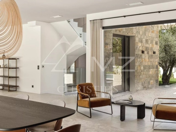 Interior of a contemporary villa in Mougins, with a modern living room and large windows.