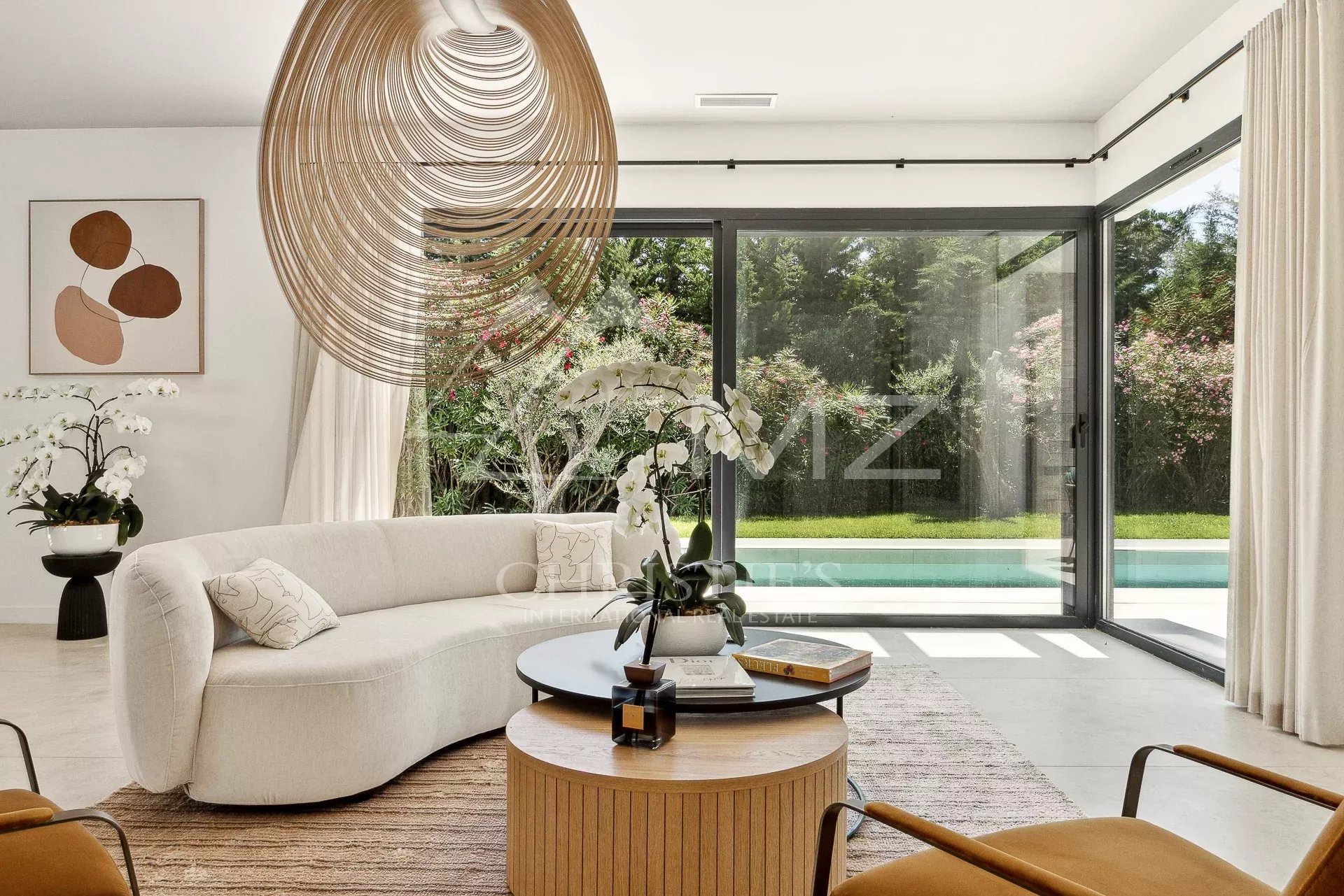 Living room of a contemporary villa in Mougins Interior of a contemporary villa with a bright living room and a view of the garden.