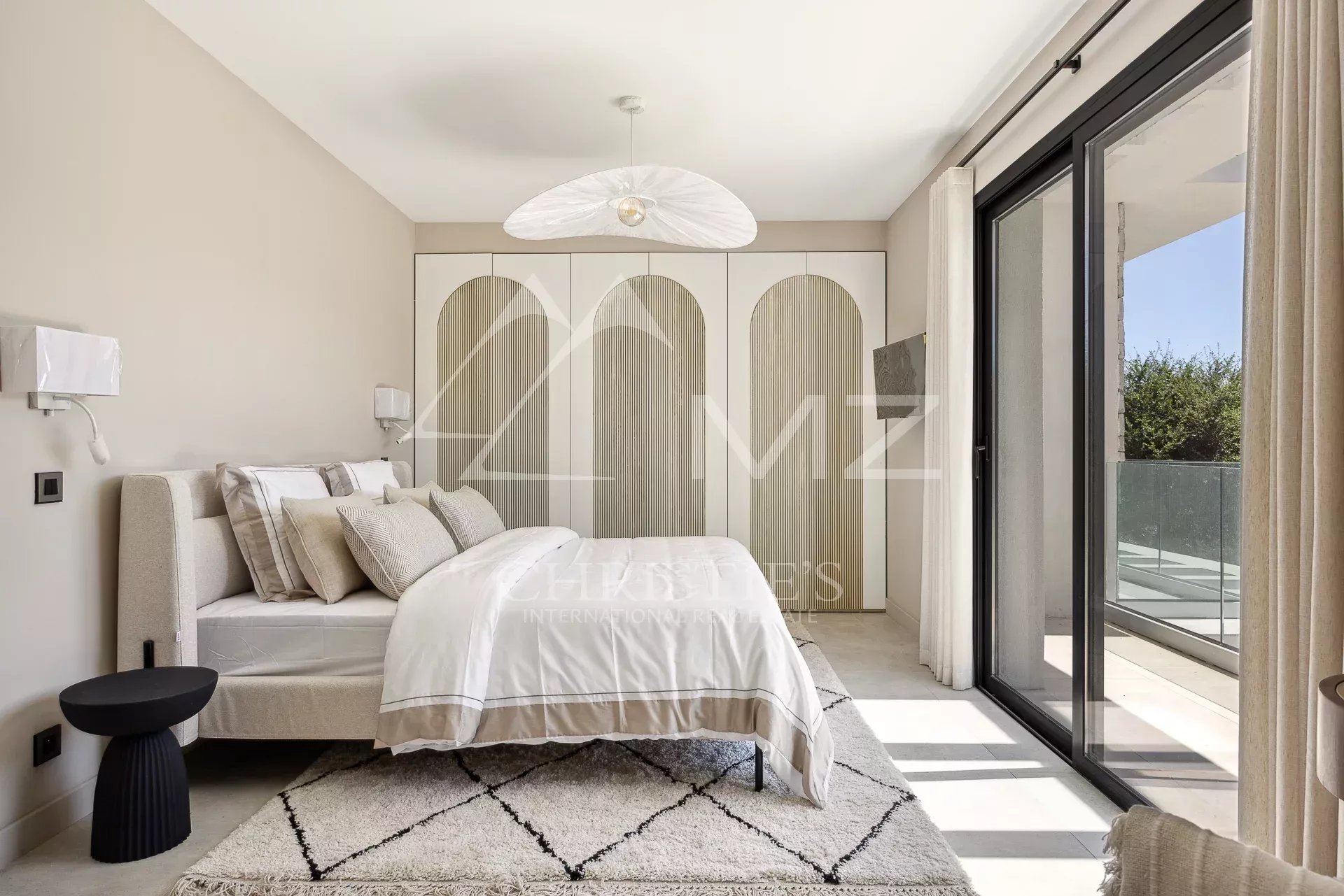 Contemporary room in a villa in Mougins Modern room with bed, minimalist decor and access to a balcony.