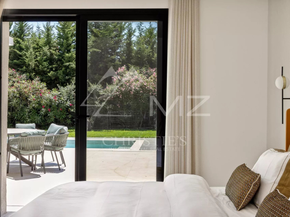 View from a bedroom with access to the terrace and swimming pool in a contemporary villa in Mougins.