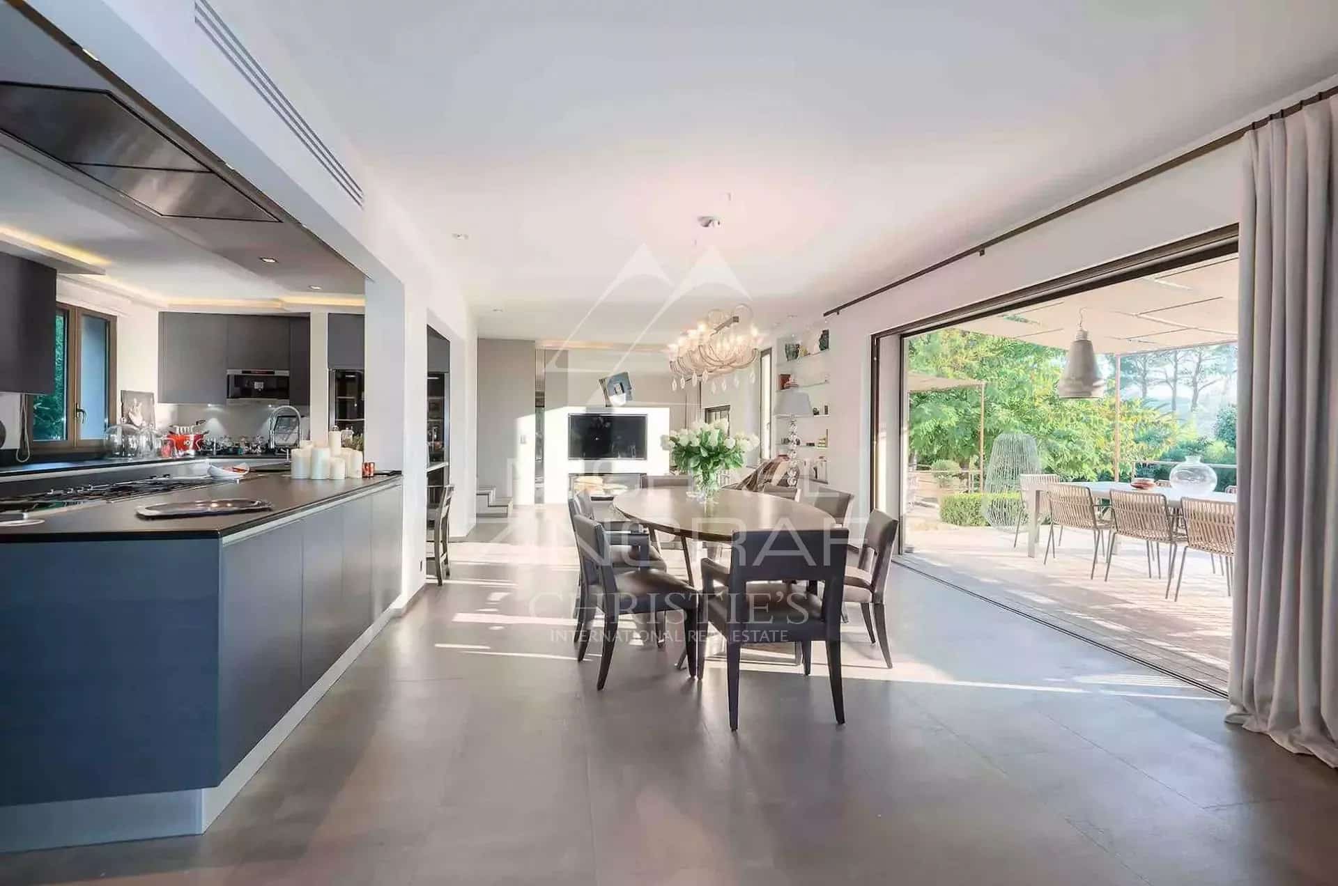 Interior of a renovated country house in Mougins Interior of a renovated villa with a modern kitchen and a bright dining room.