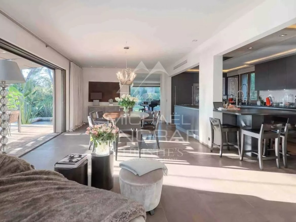 Bright interior of a renovated bastide with living room and open kitchen in Mougins.