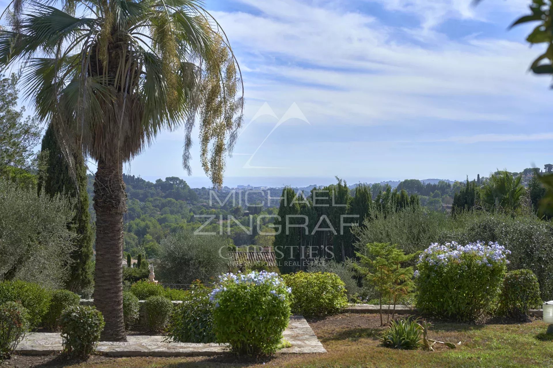 Unobstructed view of the hills and the old village of Mougins from a wooded area.