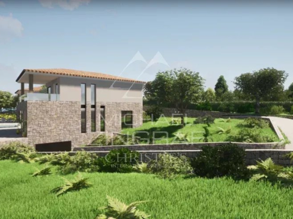 View of a plot of land in Mougins with an existing villa and building permit, surrounded by greenery.