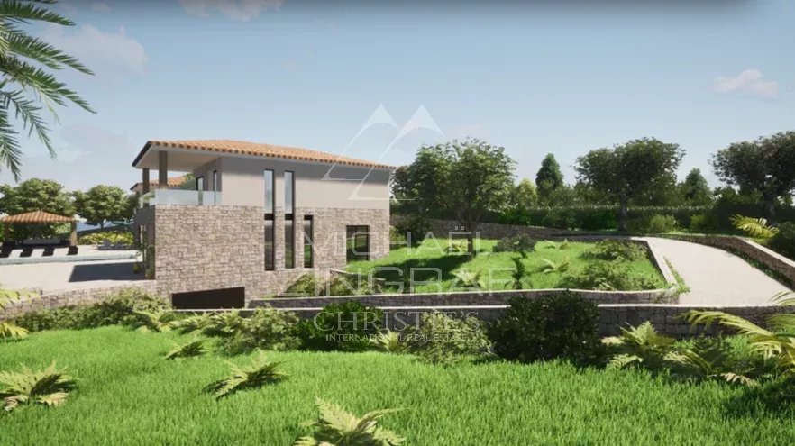 View of a plot of land in Mougins with an existing villa and building permit, surrounded by greenery.
