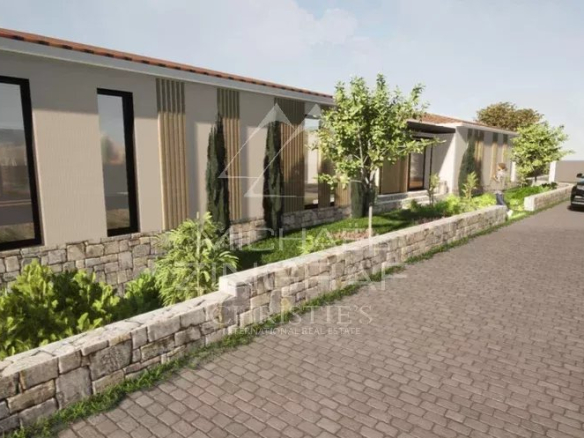 View of a plot of land in Mougins with existing villa and landscaping.