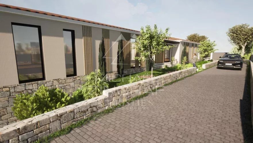 View of a plot of land in Mougins with existing villa and landscaping.