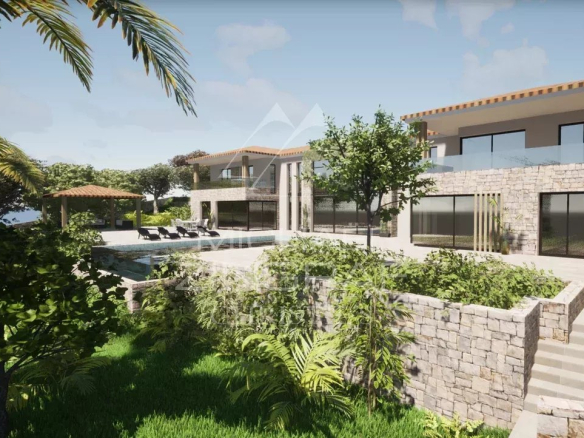 View of a plot of land in Mougins with an existing villa and a construction project, surrounded by greenery.