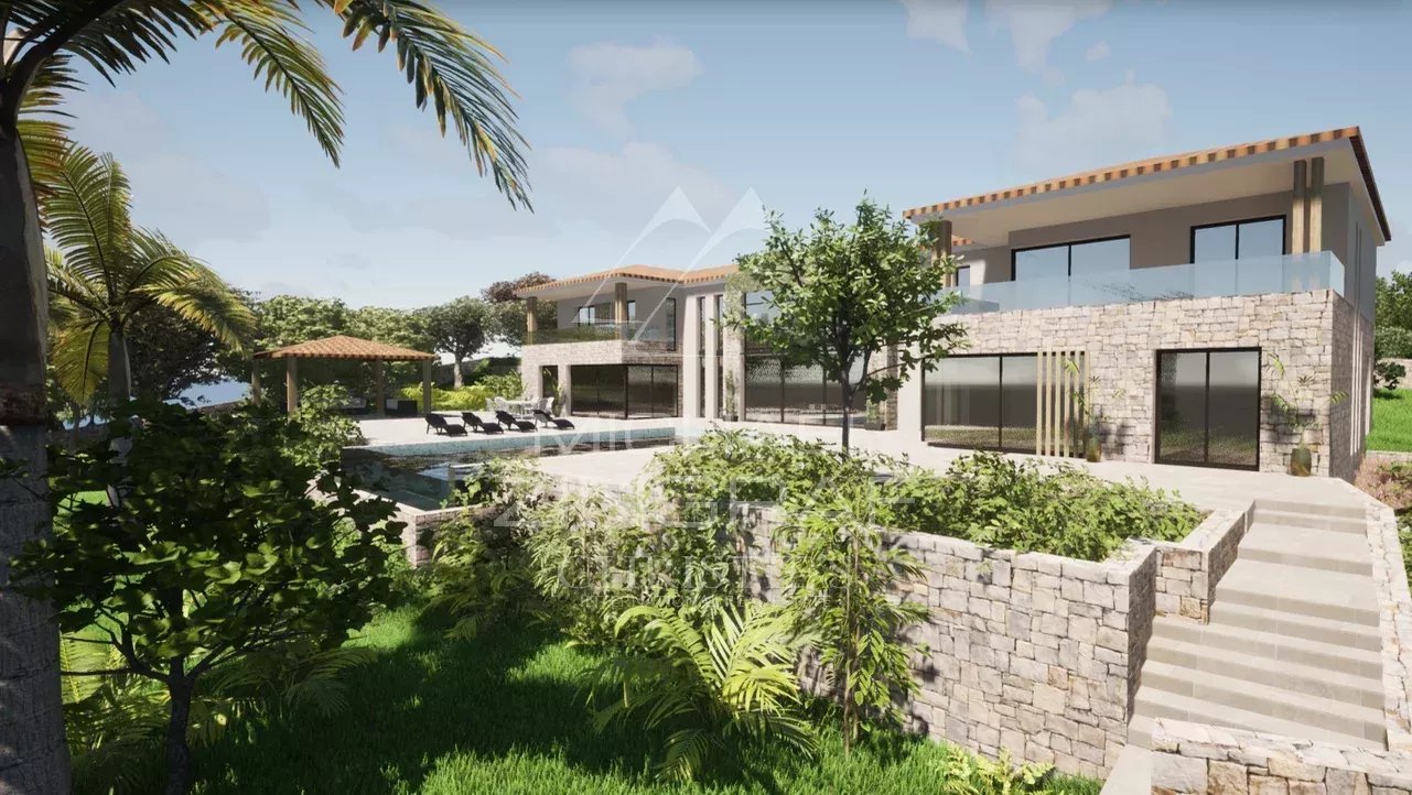 View of a plot of land in Mougins with an existing villa and a construction project, surrounded by greenery.