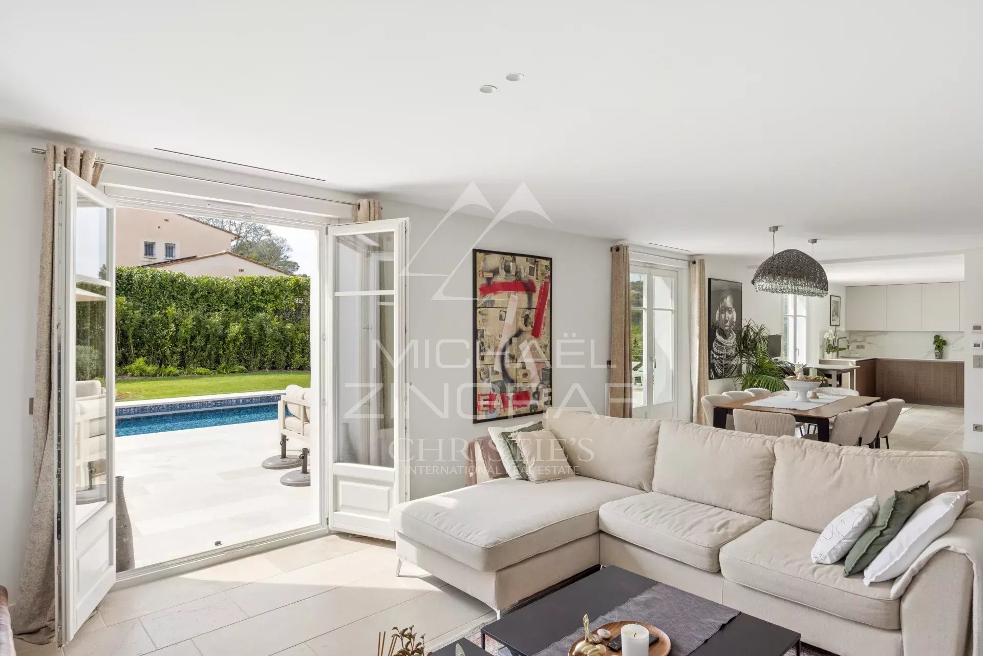 Interior of a villa in Mougins Interior of a renovated villa with a bright living room and access to the outdoor pool.