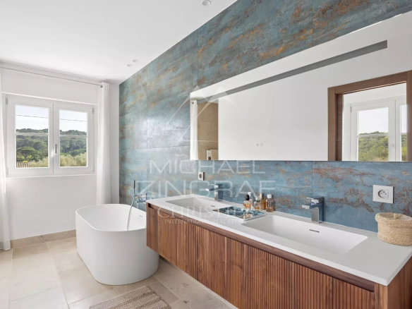 Modern bathroom with bathtub and wooden furniture in a renovated villa in Mougins.