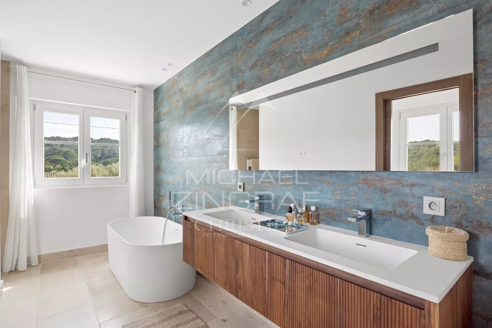 Renovated bathroom in Mougins Modern bathroom with bathtub and wooden furniture in a renovated villa in Mougins.