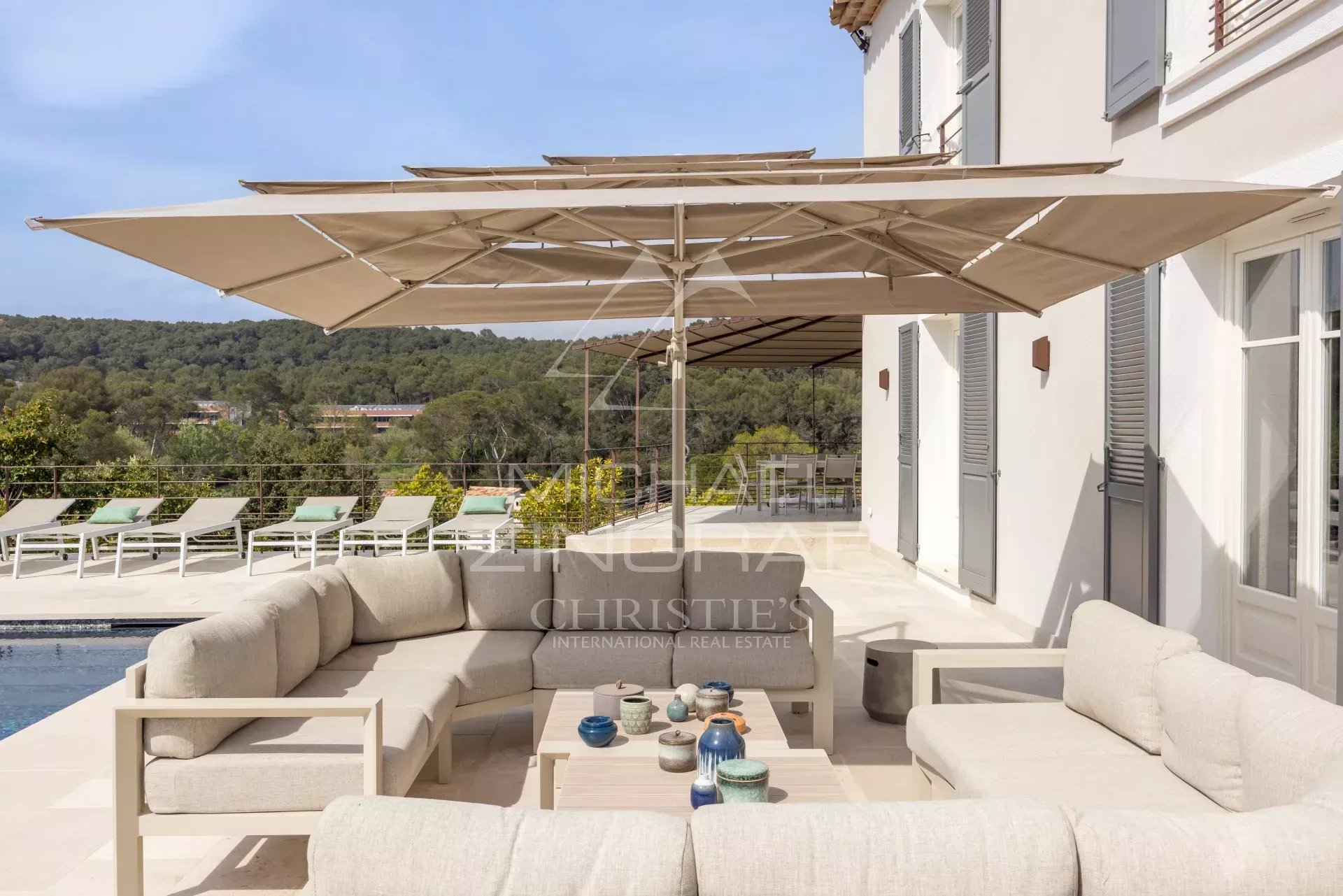 Villa terrace in Mougins Terrace of a renovated villa with garden furniture and parasol, overlooking nature in Mougins.