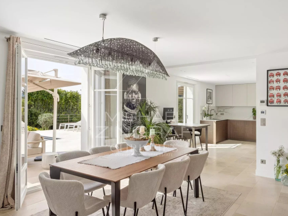 Interior of a renovated villa with modern dining room and access to the outside.