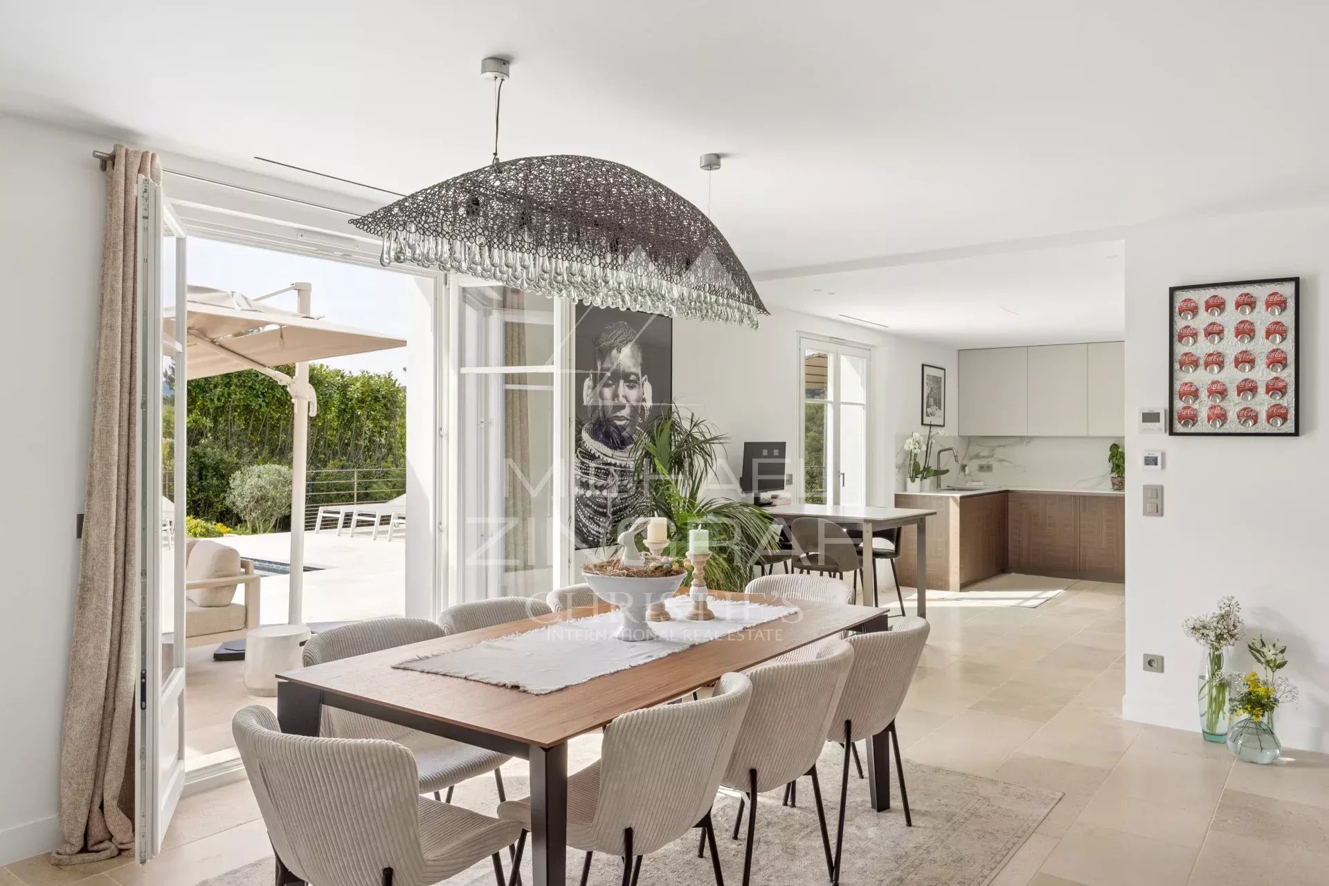 Interior of a renovated villa in Mougins Interior of a renovated villa with modern dining room and access to the outside.