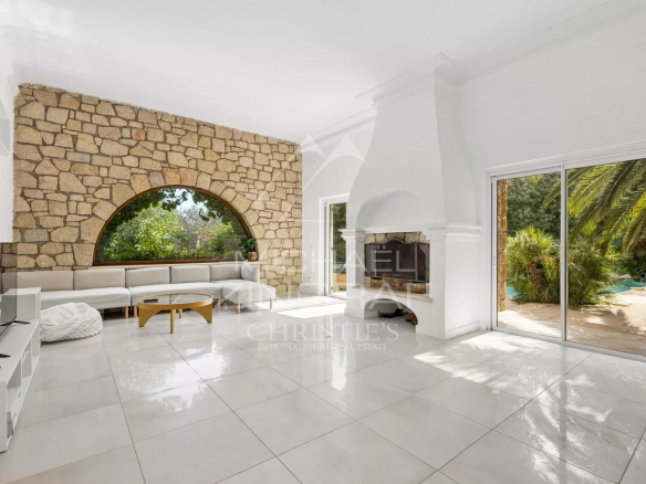 Interior of a Provençal villa in Mougins with a large, bright living room and a fireplace.