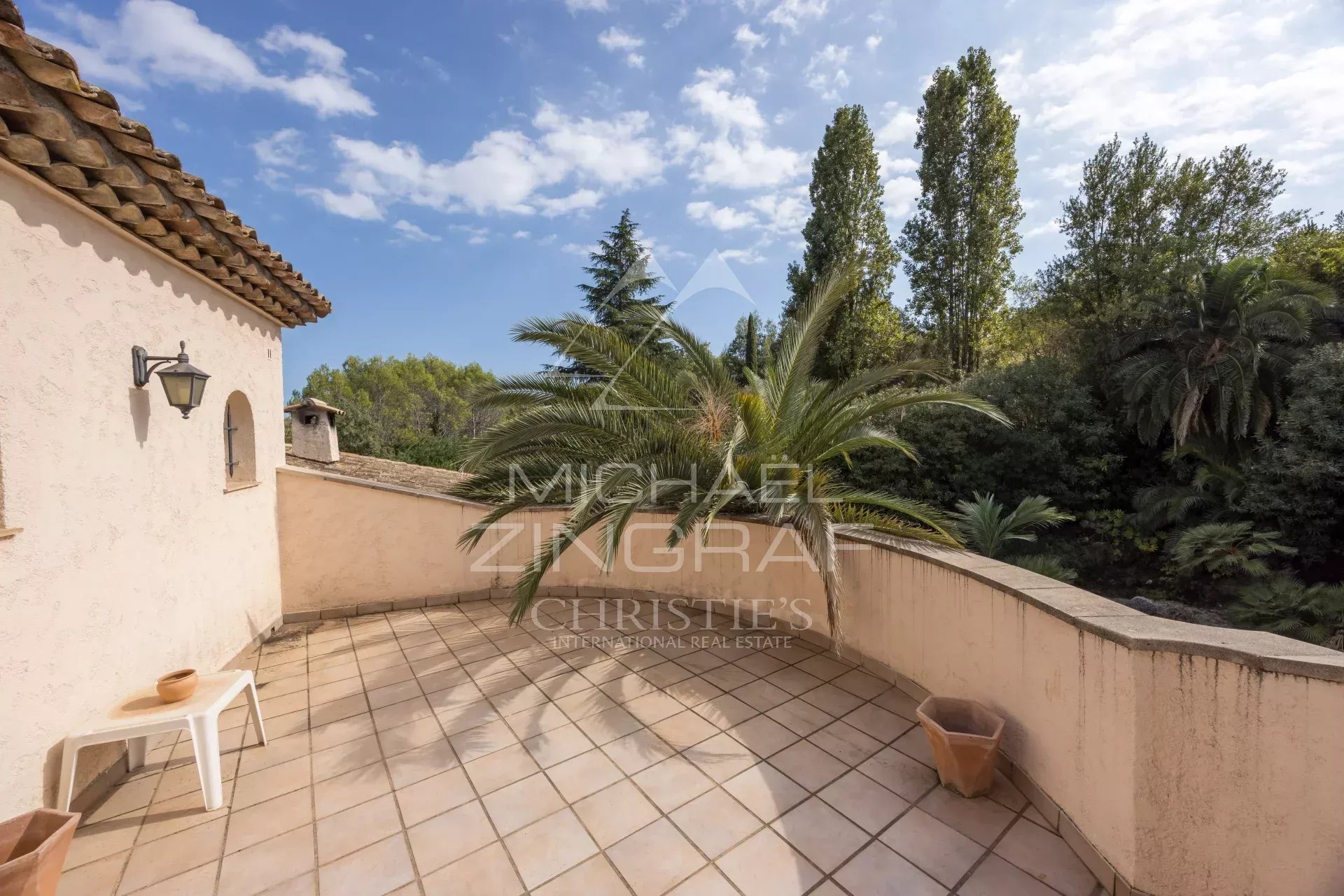 Terrace of a Provençal villa overlooking greenery in Mougins.