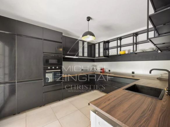 Modern kitchen with black furniture and wooden worktop in a villa in Mougins.