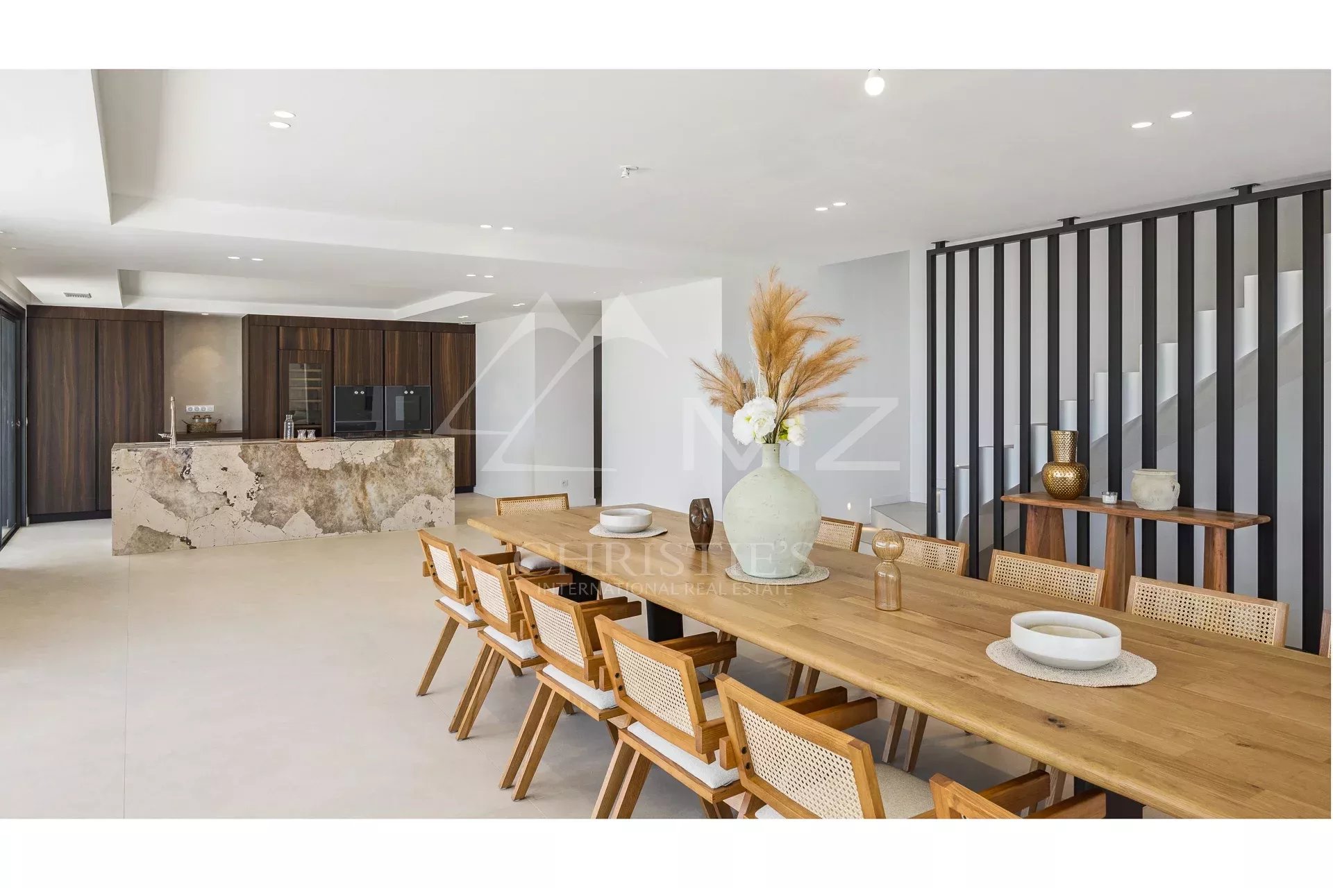 Interior of a contemporary villa in Les Issambres Interior of a contemporary villa with a large wooden table and a modern kitchen in Les Issambres.