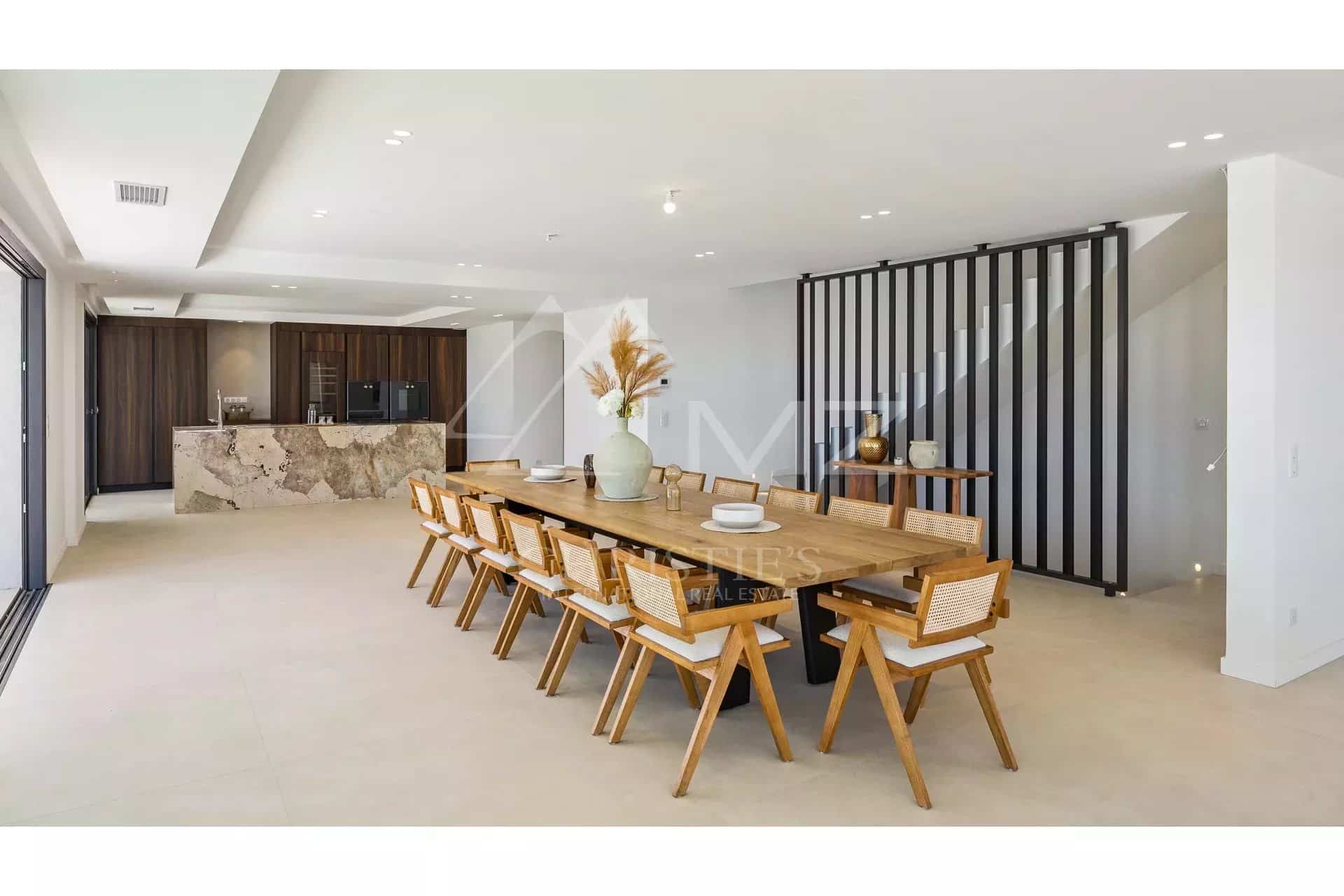 Interior of a contemporary villa Interior of a contemporary villa with a large dining table and an open kitchen.