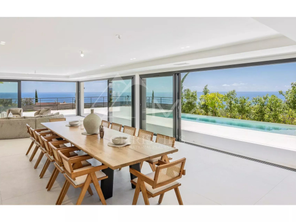 Interior of a contemporary villa with sea views, spacious dining room and swimming pool