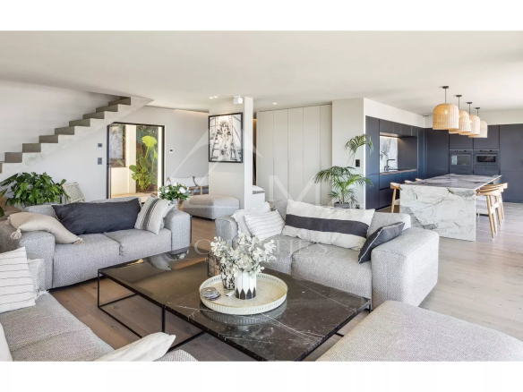 Interior of a contemporary villa with a spacious living room and open kitchen in Les Issambres.