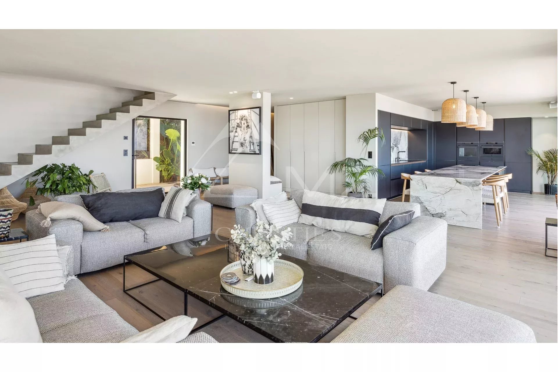 Interior of a contemporary villa with a spacious living room and open kitchen in Les Issambres.