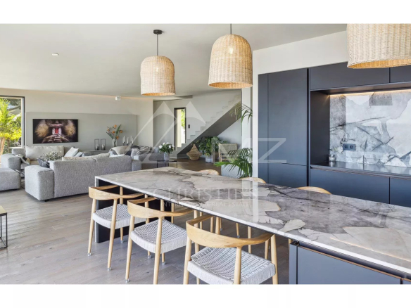 Interior of a contemporary villa with modern kitchen and bright living room in Les Issambres.