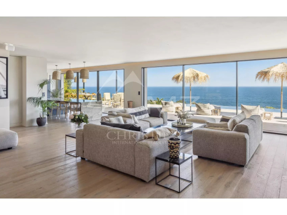 Interior of a contemporary villa with sea views, modern furniture and bay windows.