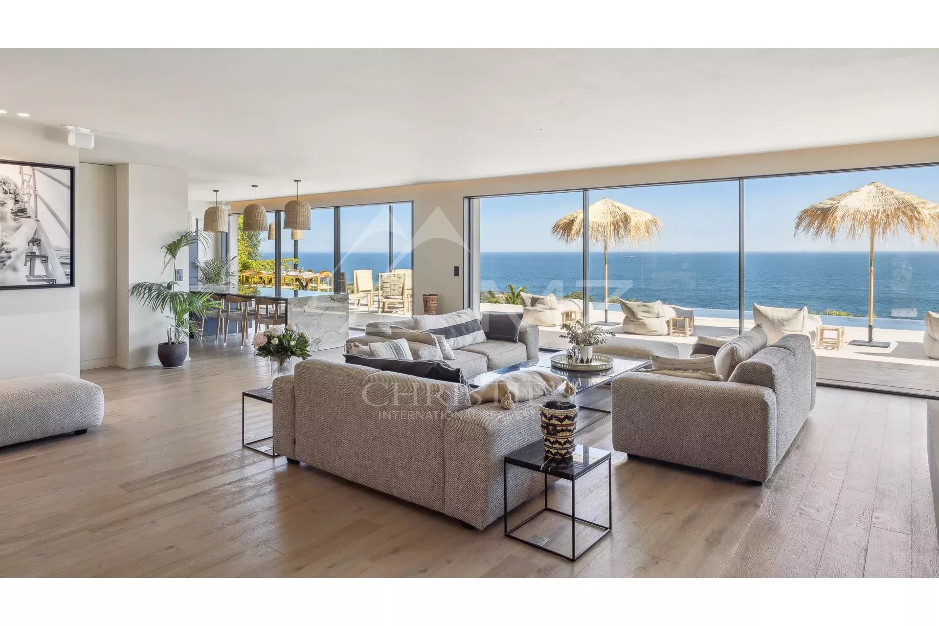 Interior of a contemporary villa with sea views, modern furniture and bay windows.